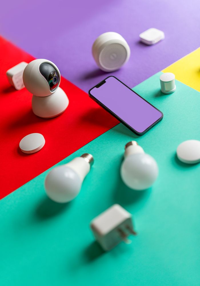 about-us-02 Modern smart home gadgets displayed on a colorful abstract background with vibrant lighting.